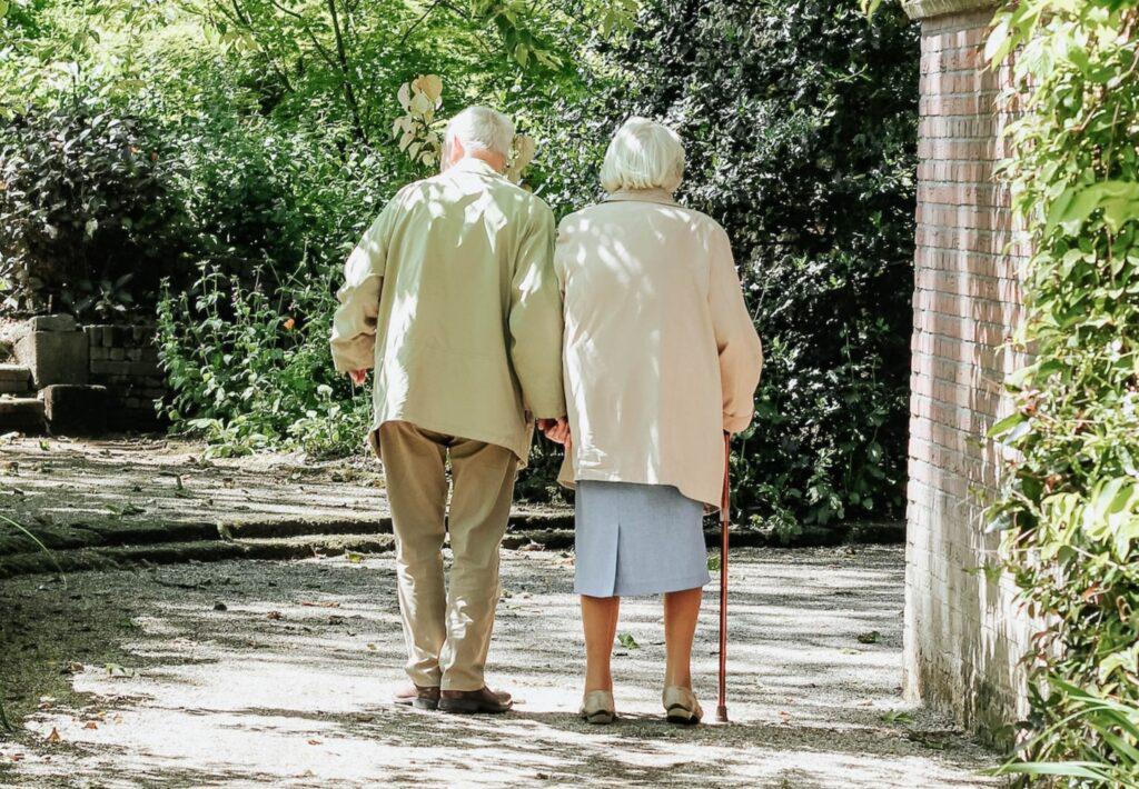 An elderly couple walk together