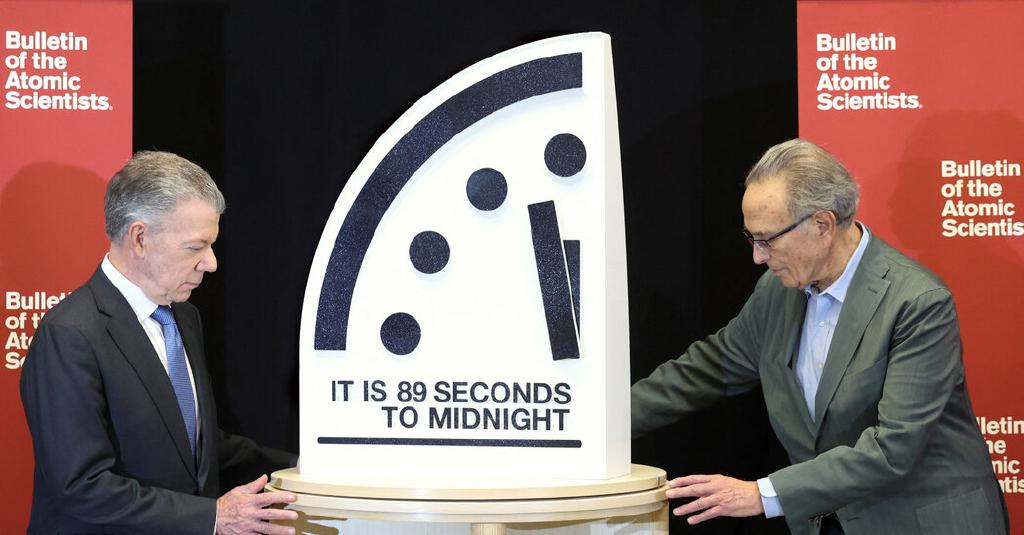 Members of the board of the ‘Bulletin of Atomic Sciences’ place the Doomsday clock, pointing at 89 seconds to midnight.